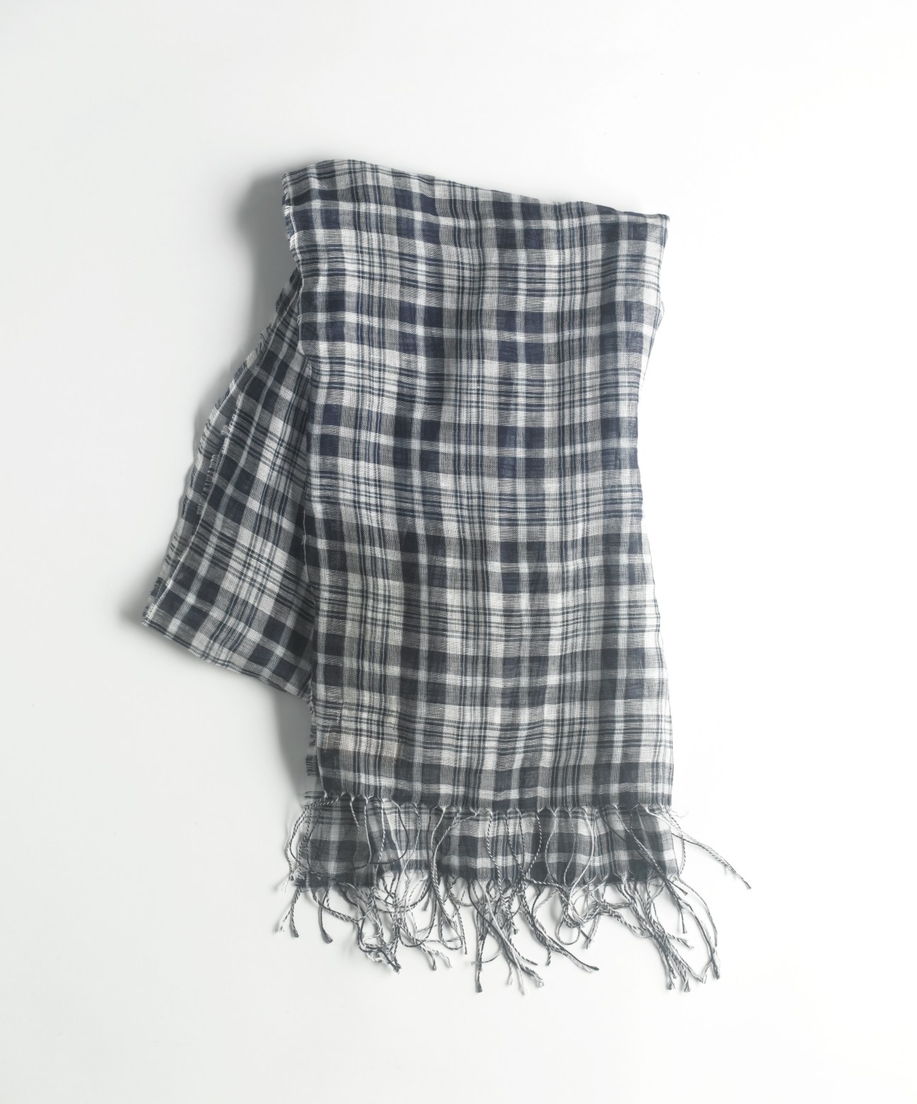 Navy and white plaid linen scarf with frayed edges displayed against a light background.