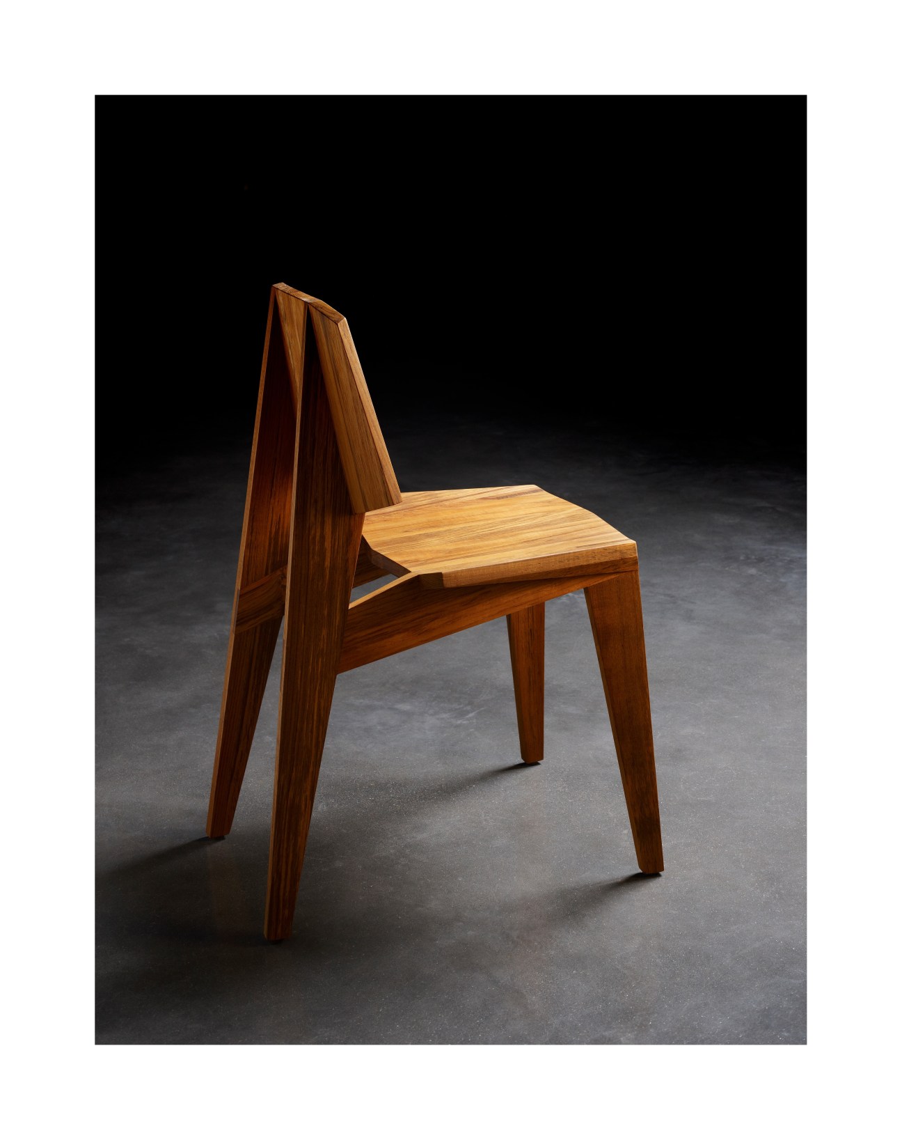 Teak wood chair with angled back and wooden seat from Inch Furniture's Swiss Pavilion collection.