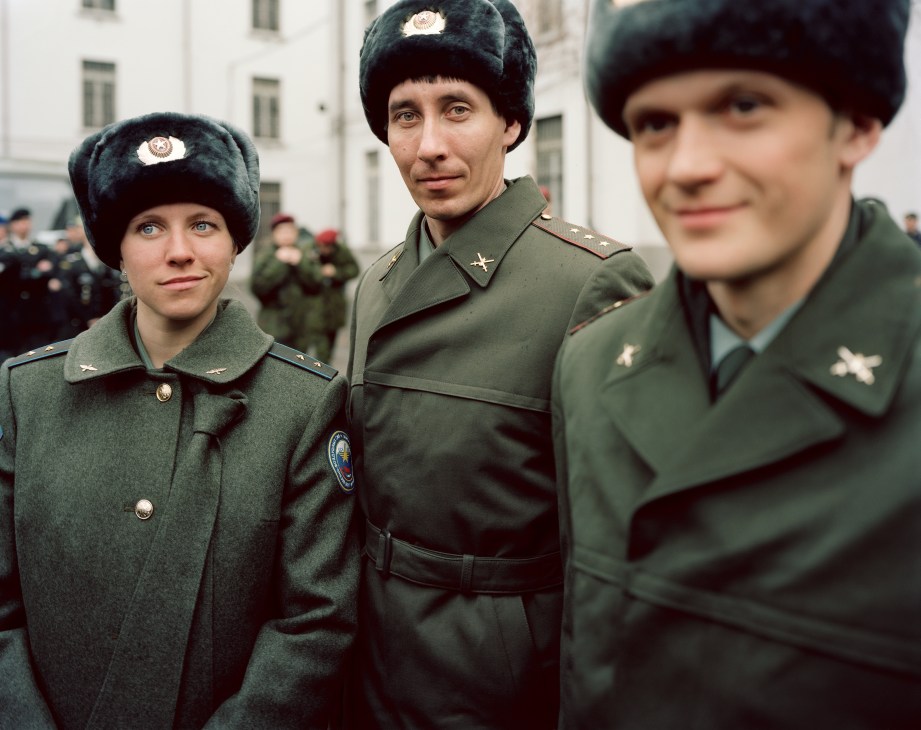 Russian military athletes in uniform with fur hats standing at the Winter Military World Games.