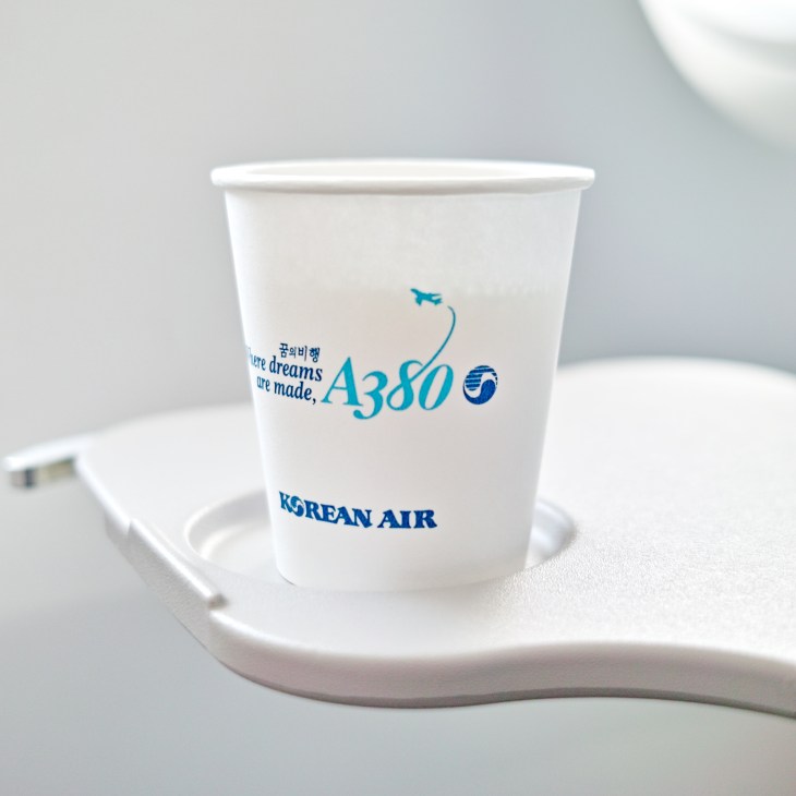 Korean Air A380 commemorative cup with aircraft logo and "Where dreams are made" text on white holder.