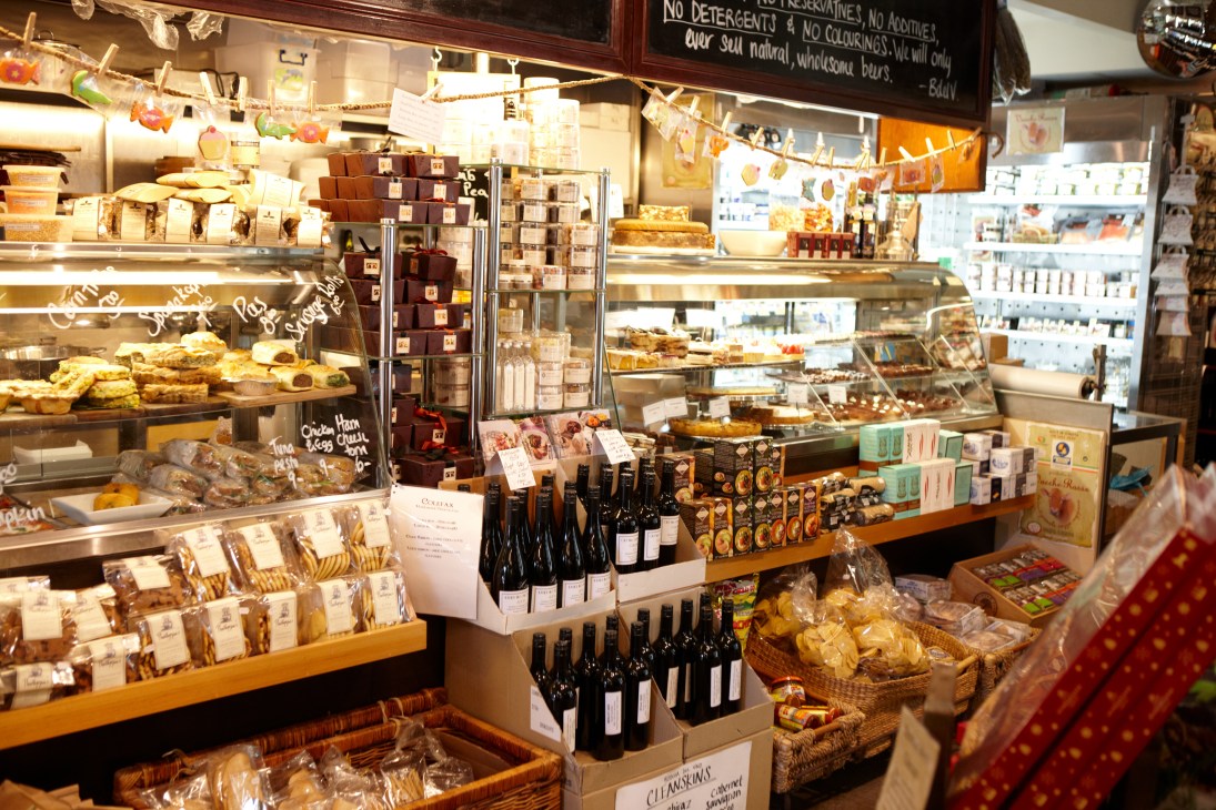 Interior of Bottega del Vino deli displaying wines, baked goods, and Italian provisions.
