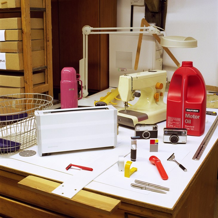 Collection of Kenneth Grange's product designs displayed on a white surface, including a Thermos flask, sewing machine, Kodak cameras, Wilkinson Sword razors, Parker pens, and other household items.