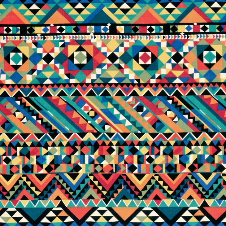 Colorful abstract geometric pattern with triangles and diamonds in blue, red, yellow, and teal.