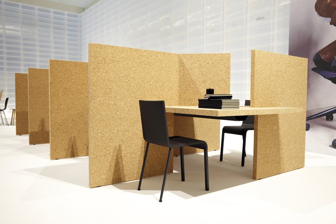 Cork Desk by Vitra with modular cork partitions and black chair in office setting.