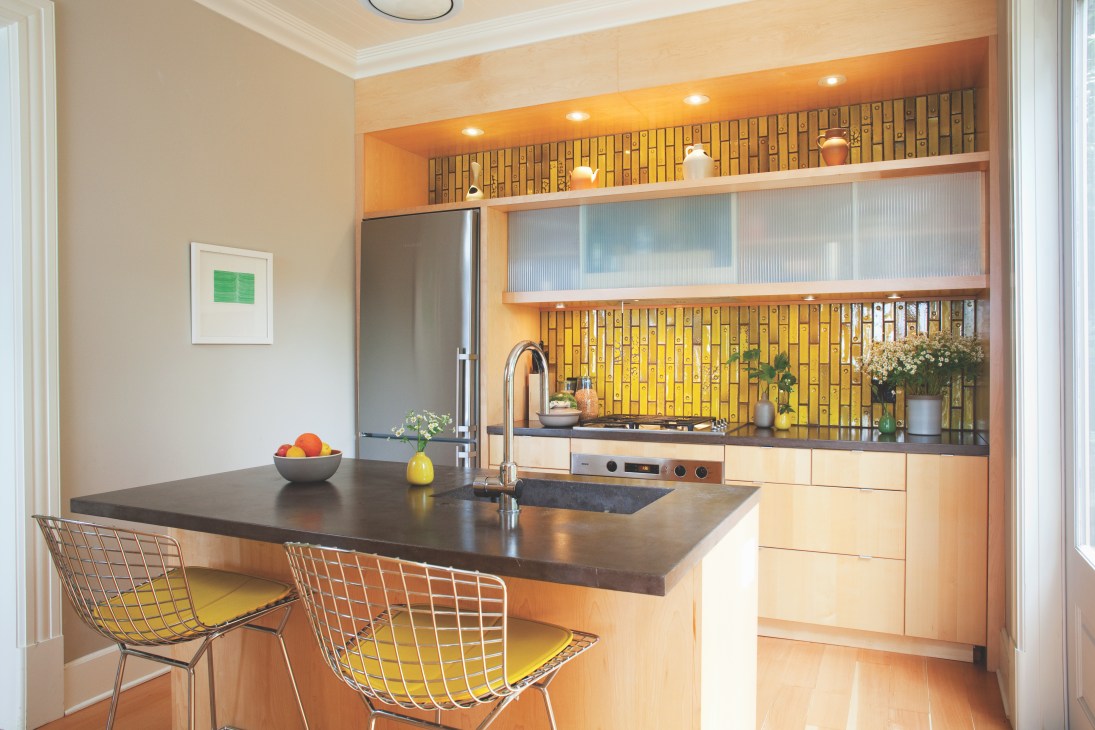 Modern kitchen with concrete counters, acid-yellow Heath ceramic tiles backsplash, and wood cabinetry.