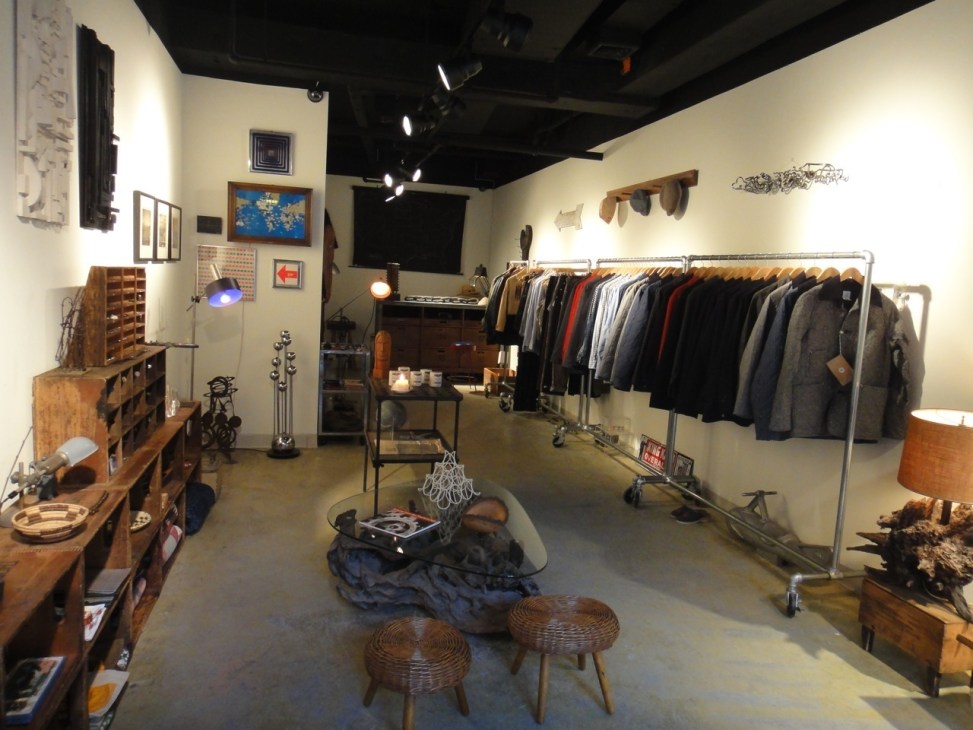 Interior of Extra boutique in Manhattan showing vintage furniture, clothing racks, and eclectic gallery display.