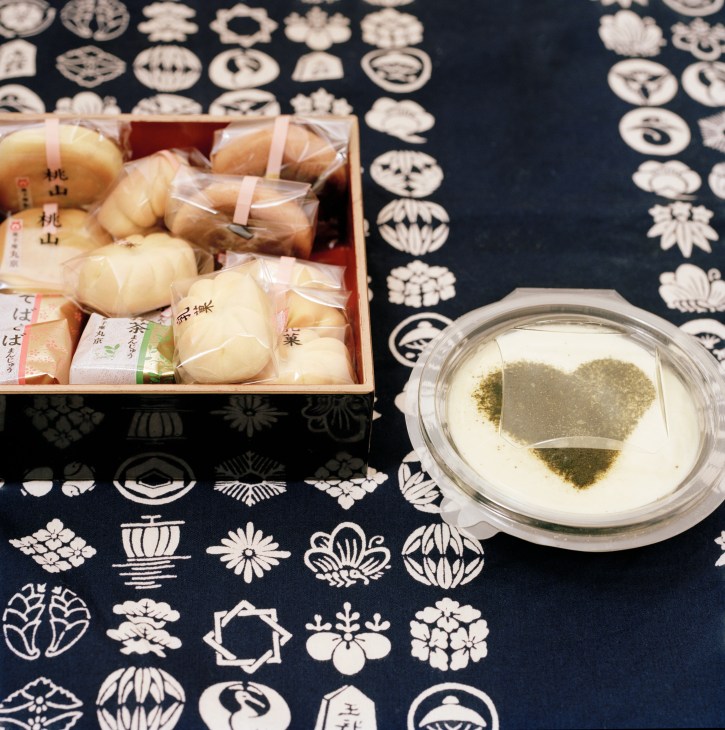 Japanese sweets and matcha tea displayed on patterned cloth at Cha No Ma café.