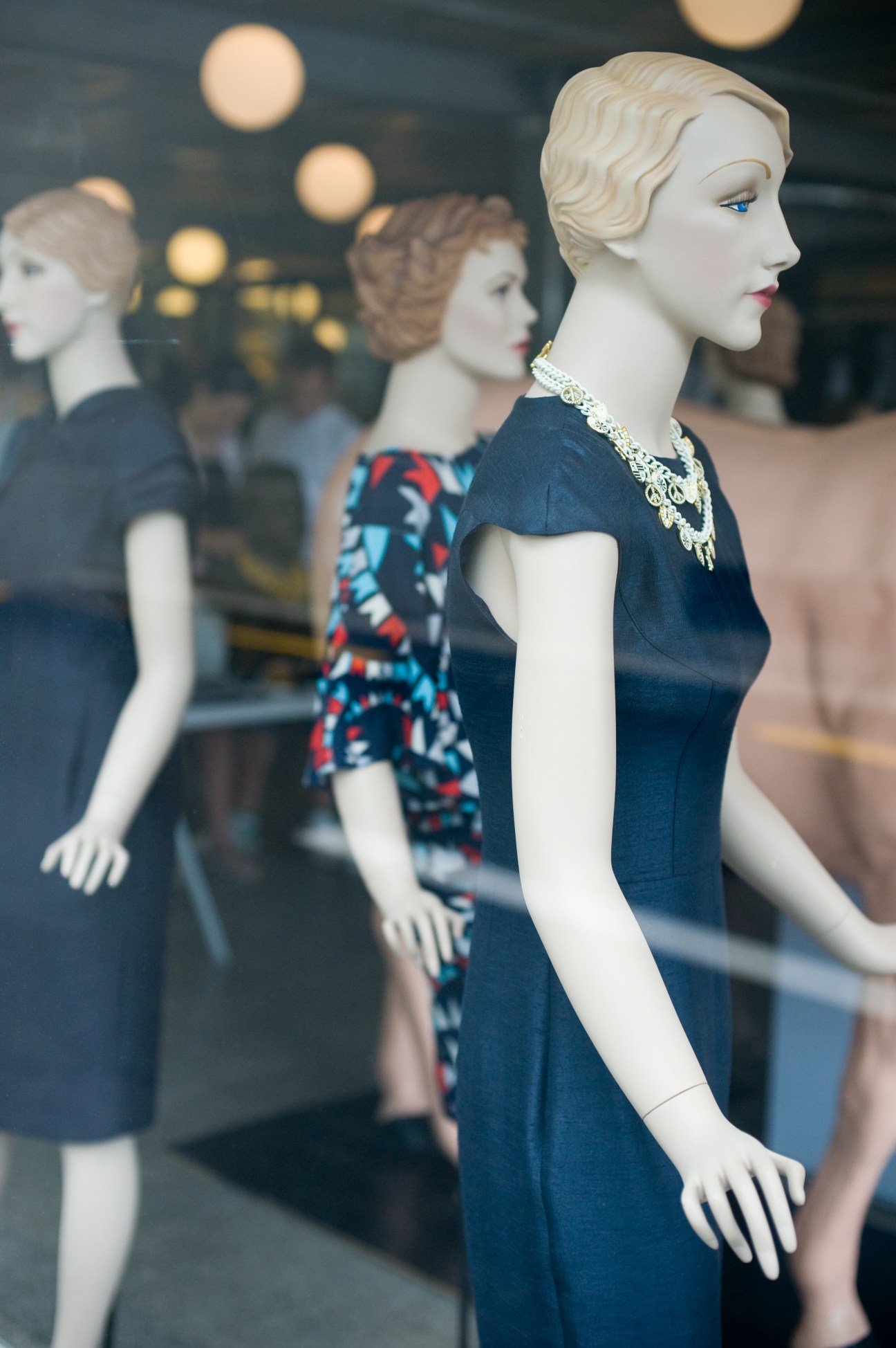 Display mannequins wearing clothing in The Department Store Auckland window.