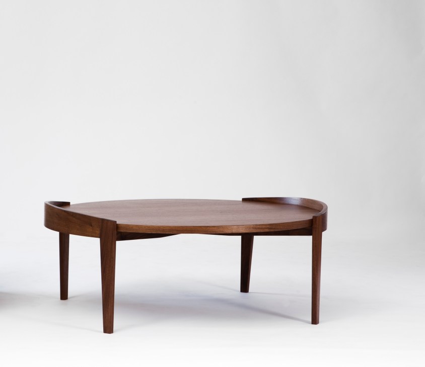 Mid-century modern wooden coffee table with curved handles and tapered legs by Jens Risom.