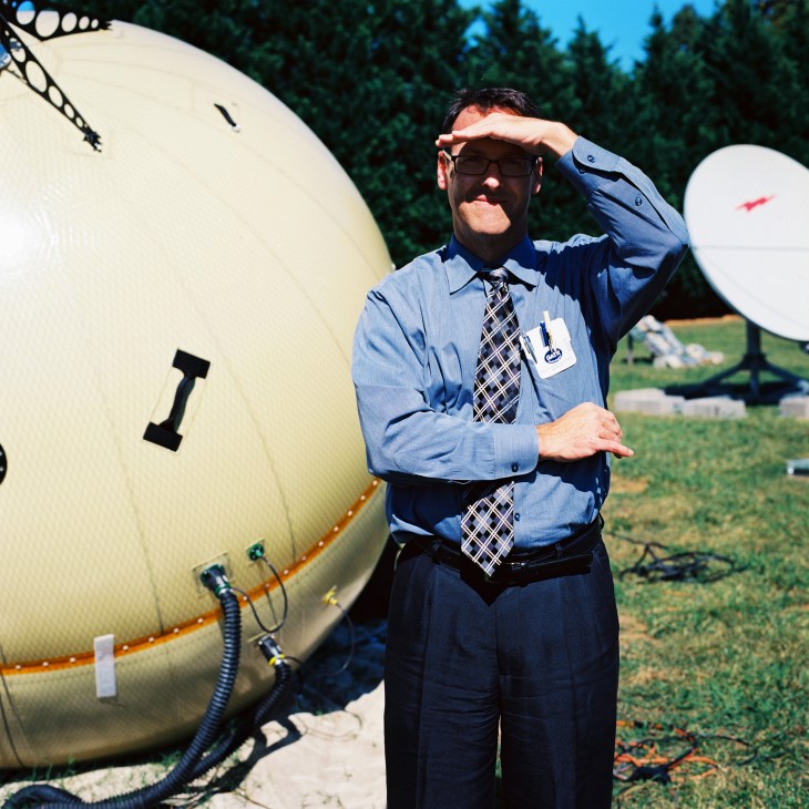 Paul Gierow stands beside an inflatable satellite transmitter designed by his firm GATR.