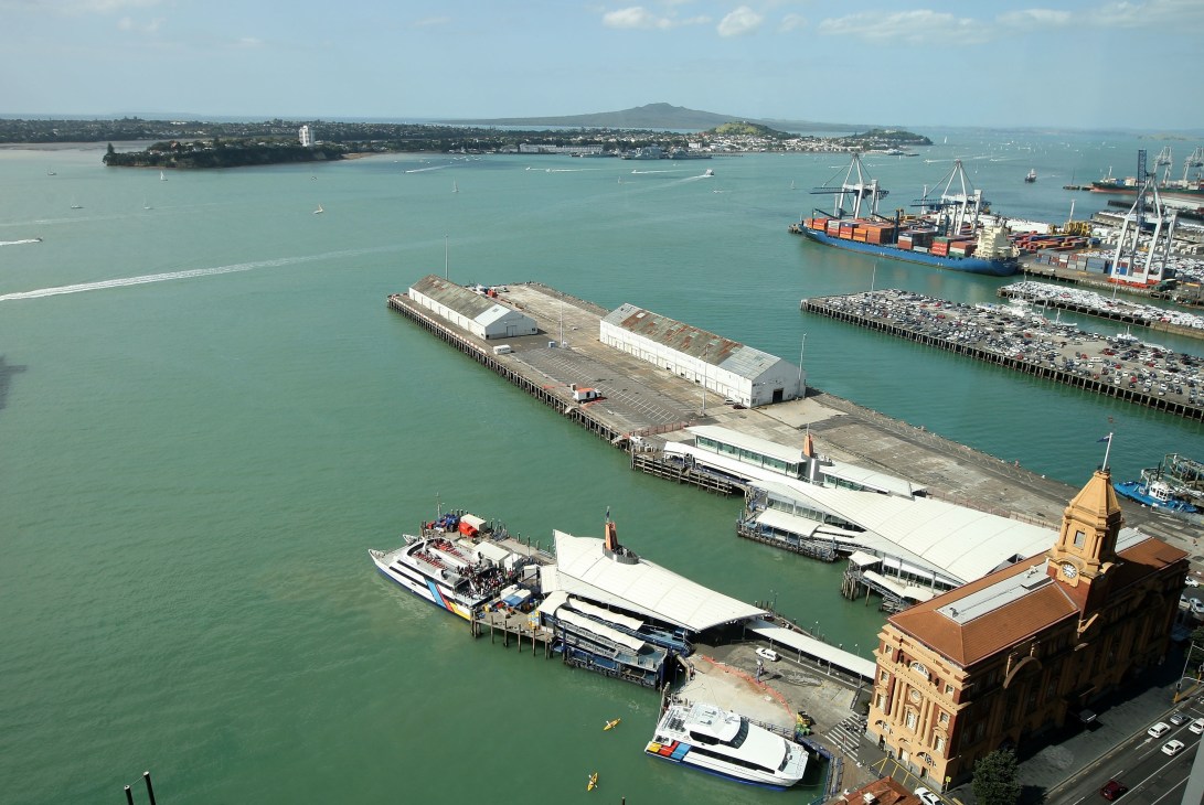 Aerial view of Auckland waterfront showing cargo sheds and temporary structures along the harbor.