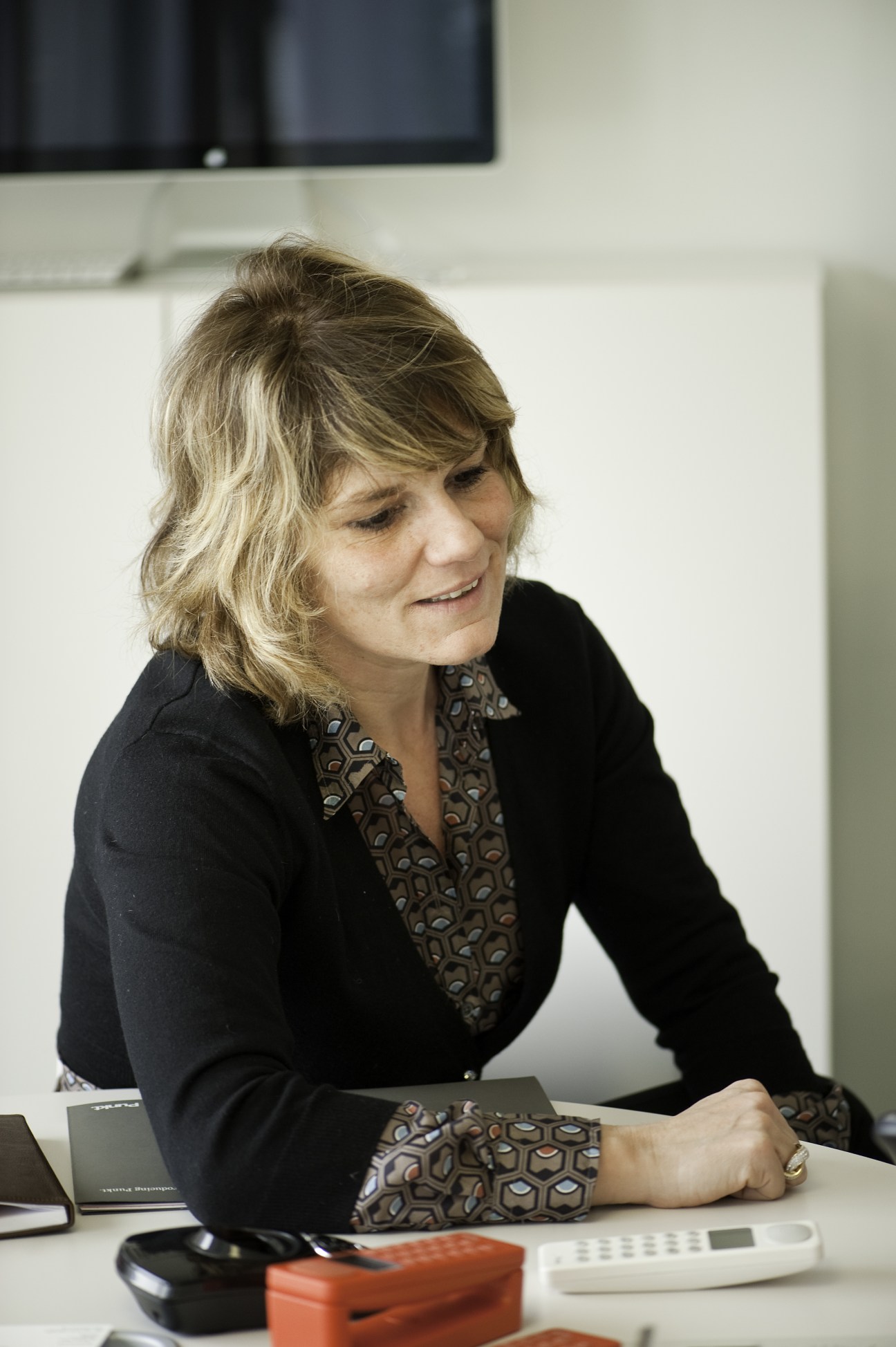 Raffaella Cardarelli, CEO of Punkt, sitting at a desk in a minimalist office with Punkt products visible.