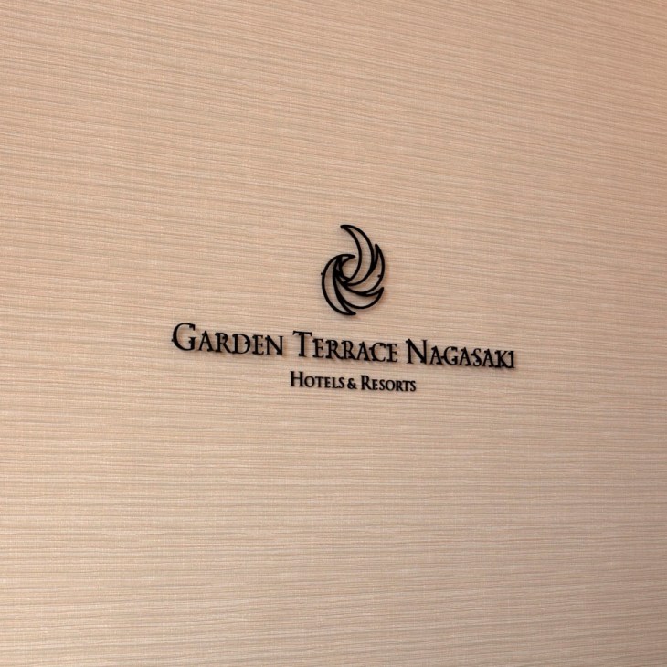 Garden Terrace Nagasaki Hotels and Resorts logo on textured beige background.