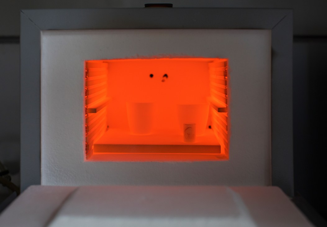Bright orange high-temperature furnace used to synthesize YInMn blue pigment at Oregon State University.