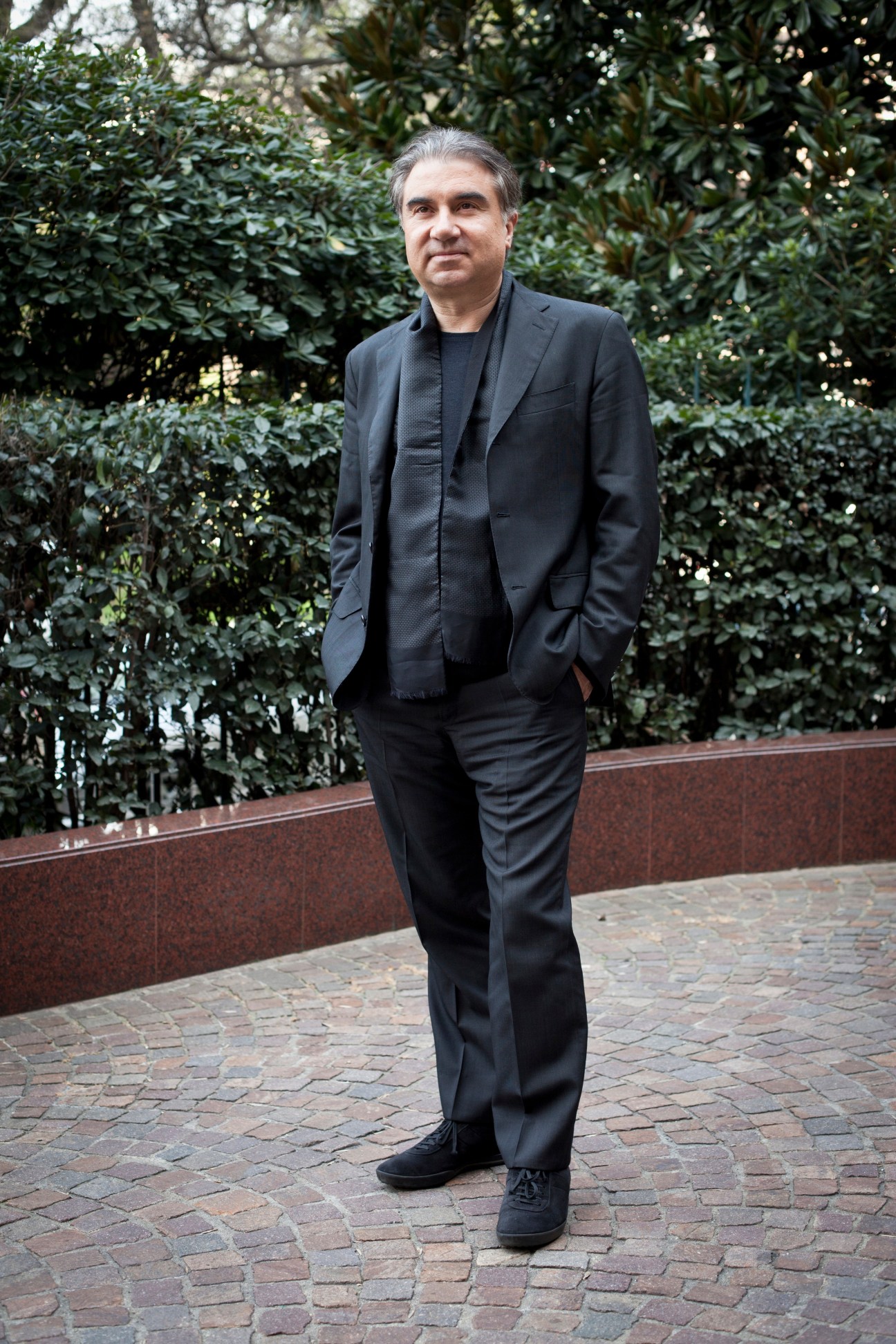 Celso Fadelli, CEO of Intertrade Europe, standing outdoors in dark clothing against ivy-covered wall.