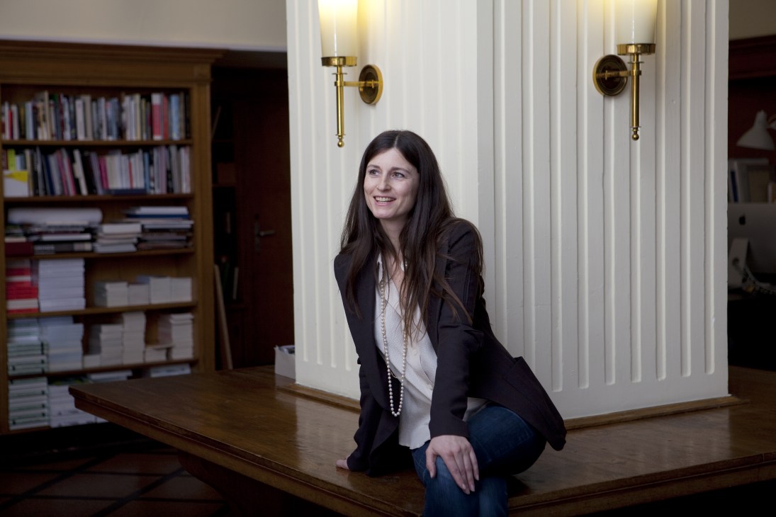 Caroline Schneider, founder of Sternberg Press, poses in her office at the former Karl Marx Buchhandlung in East Berlin.