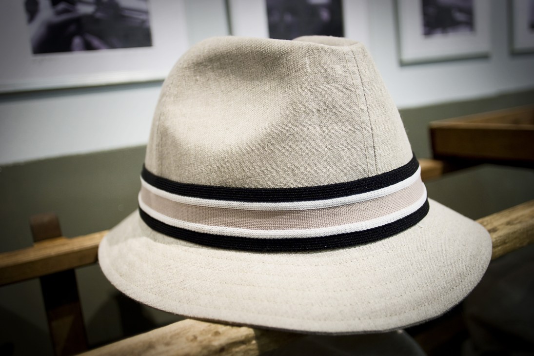 A cream-coloured Barbisio hat made from jersey fabric with black and white striped band.