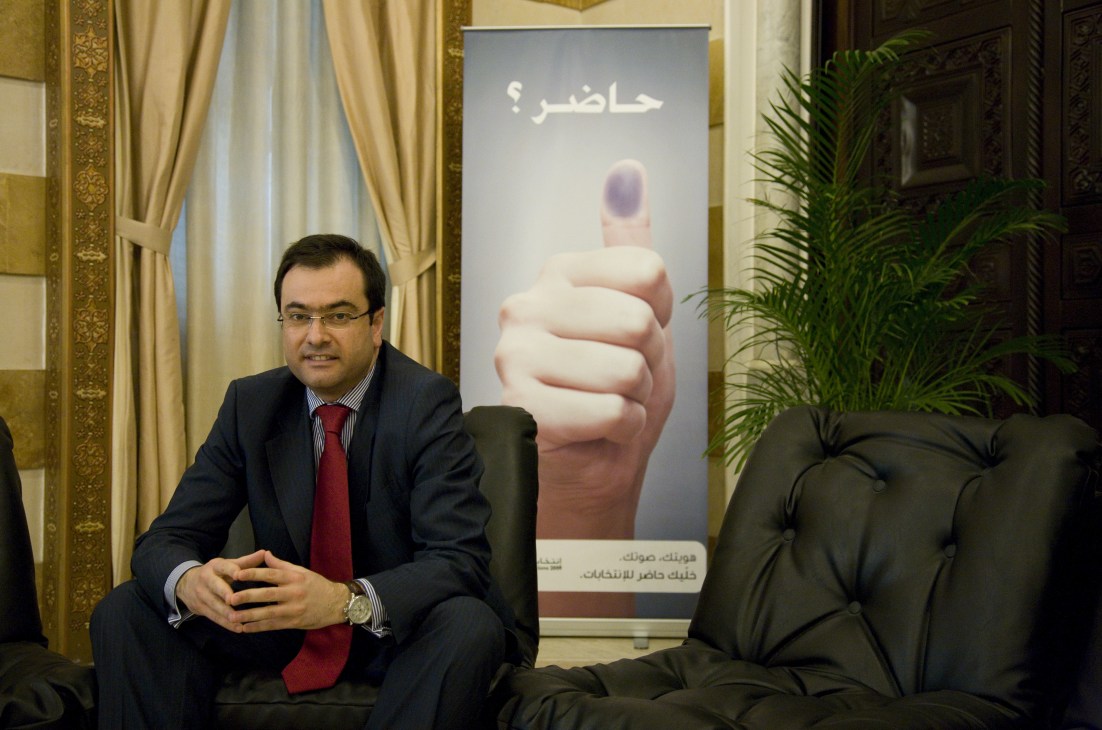 Rabih el Chaer, legal and political adviser to the minister of interior, seated in an ornate office with an election campaign poster behind him.