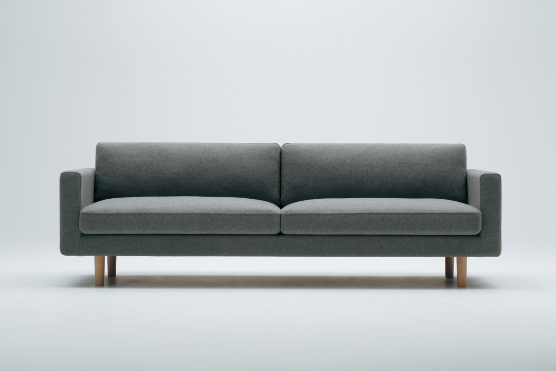 Modern gray upholstered sofa with wooden legs against a light background.