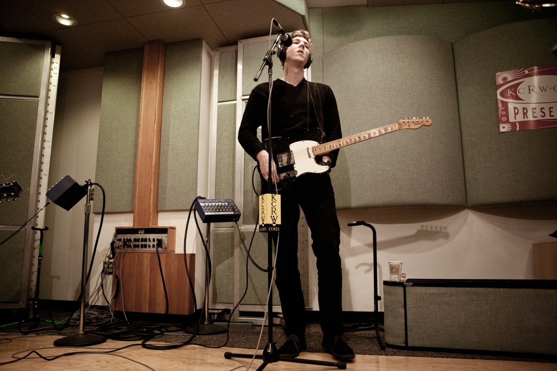 Hamilton Leithauser, vocalist for The Walkmen, performs with a guitar at a microphone in a KCRW studio.