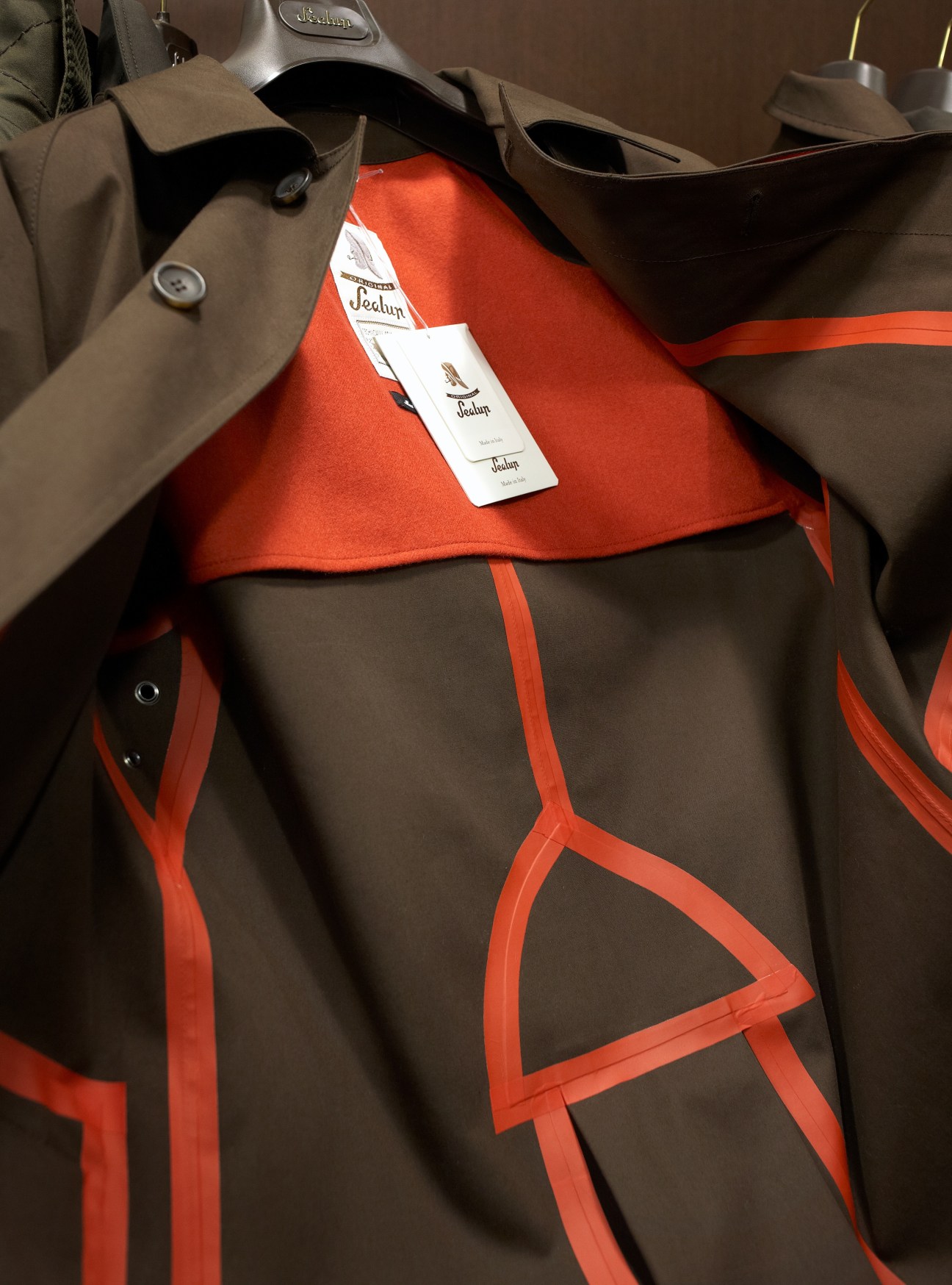 Sealup tailored jacket with orange geometric trim detail and Sealup label visible.