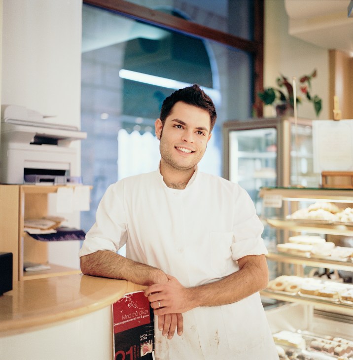 Pastry chef Vincenzo Varriale standing in a modern kitchen at Manin restaurant in Belluno, Italy