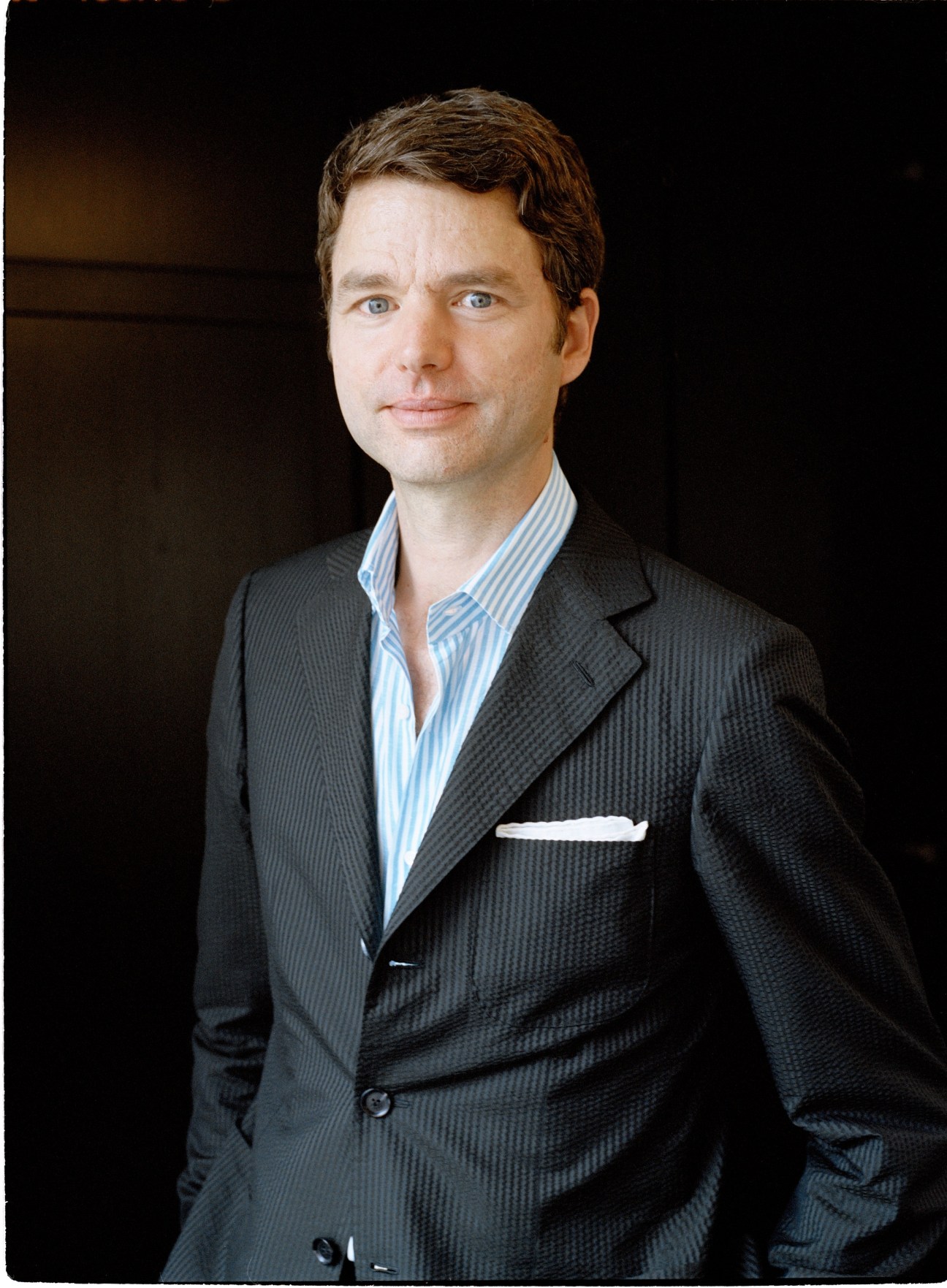 Portrait of Regent's head of design Detlev Diehm wearing a charcoal suit and blue striped shirt.