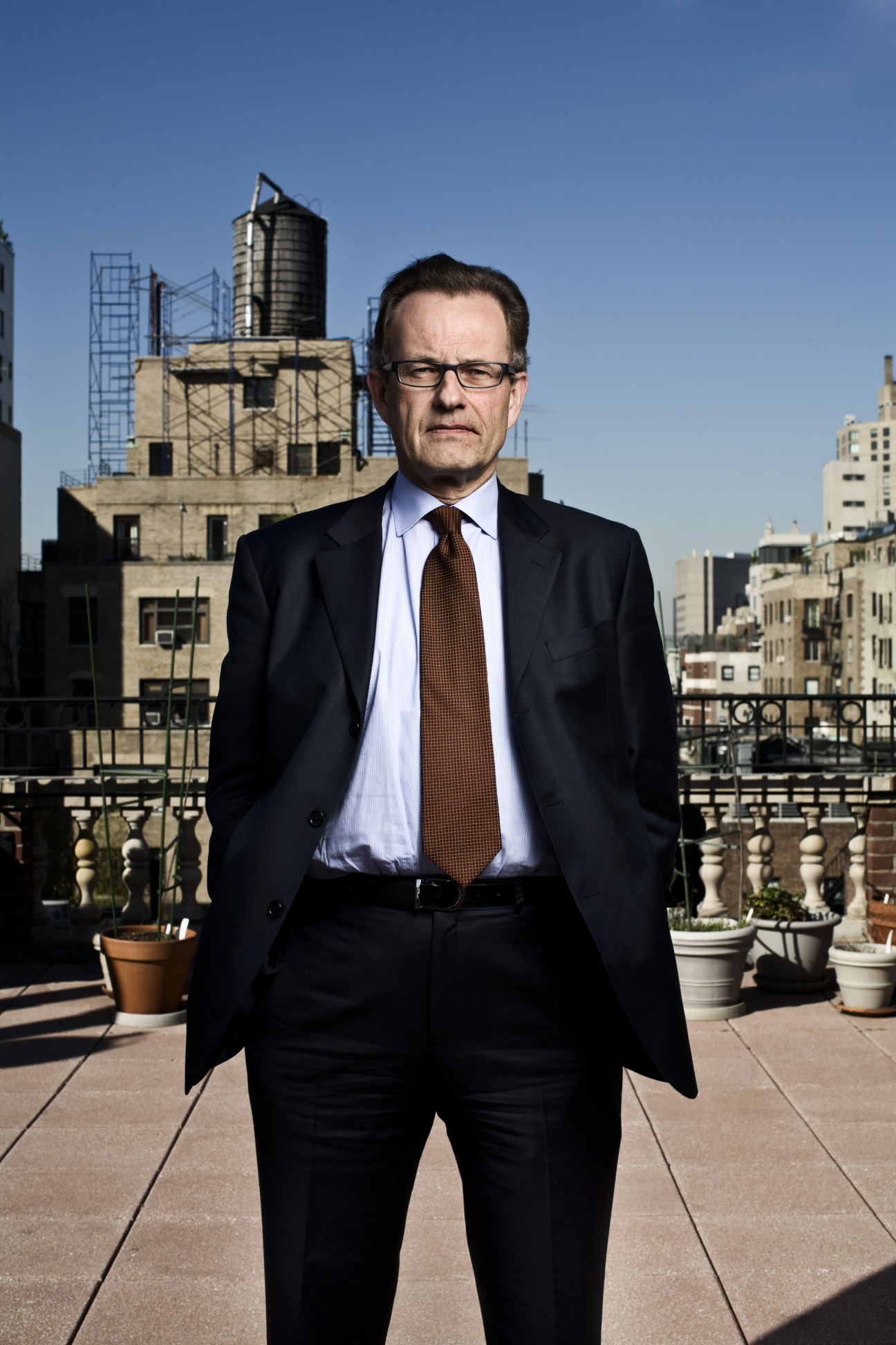 Michael Møller, former UN special representative for Cyprus, standing on a rooftop in New York with city buildings behind him.