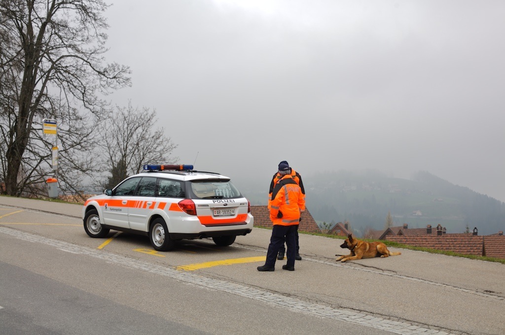 Swiss police officers with a Subaru Outback on a mountain road