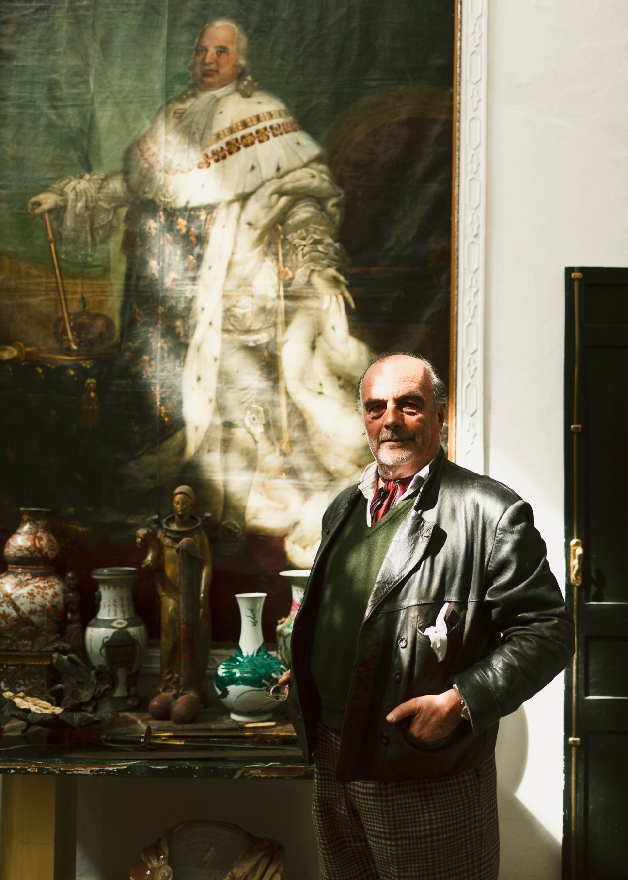 GP de Richemont standing in front of a portrait painting in an ornate interior setting.