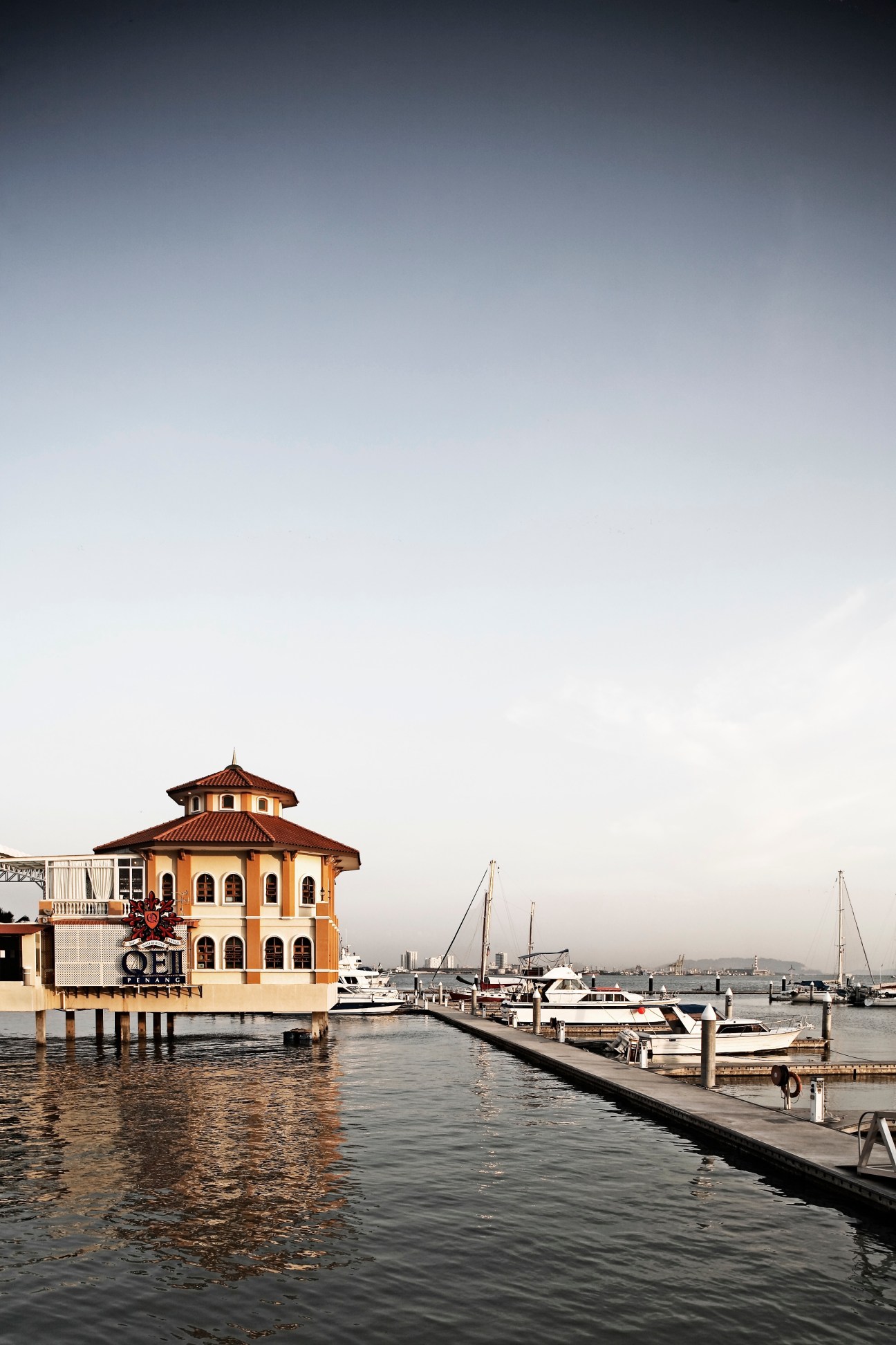 George Town marina with orange pavilion building and moored sailboats