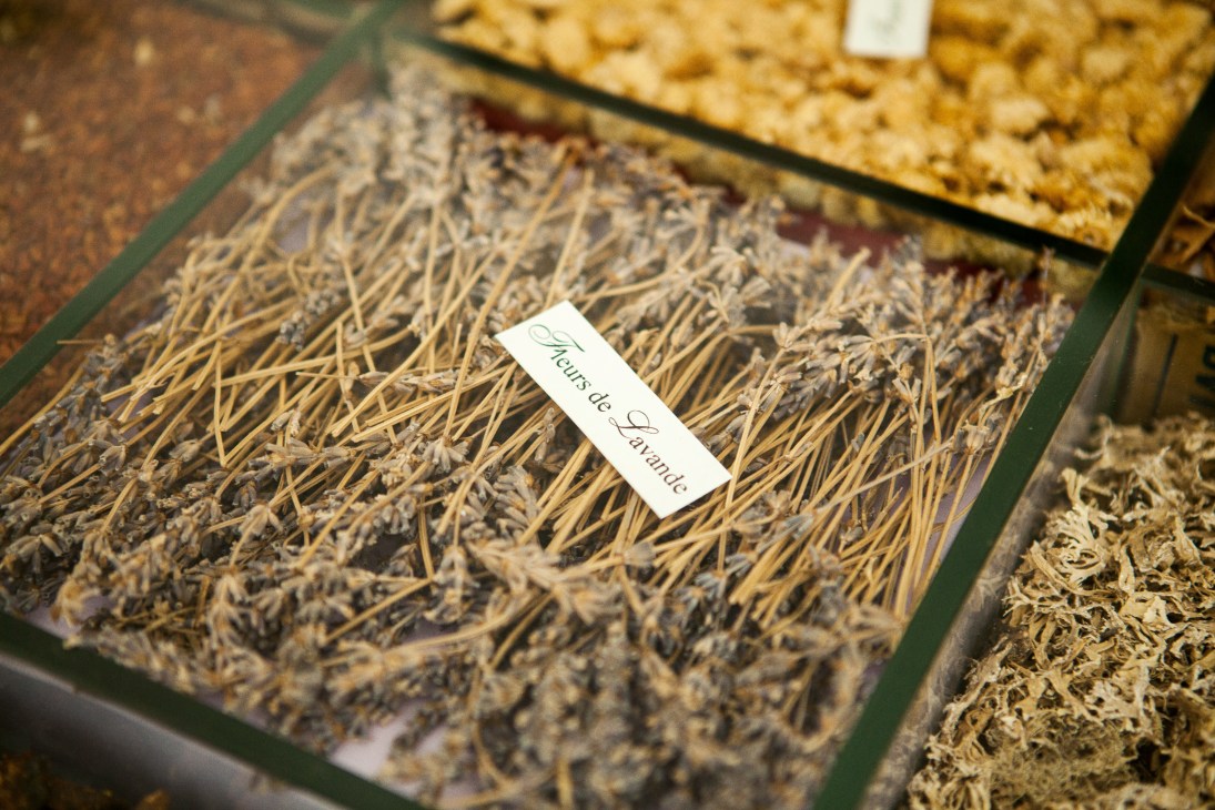 Dried lavender stems in a labeled container at a Grasse perfumery facility.