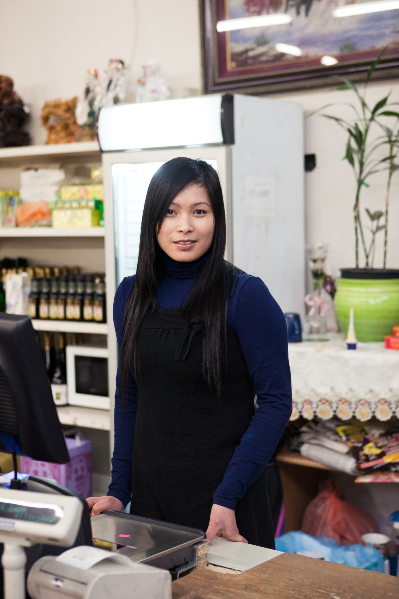 Vu Thi Jen standing behind counter in Asian Food Market at Dong Xuan Center, Berlin