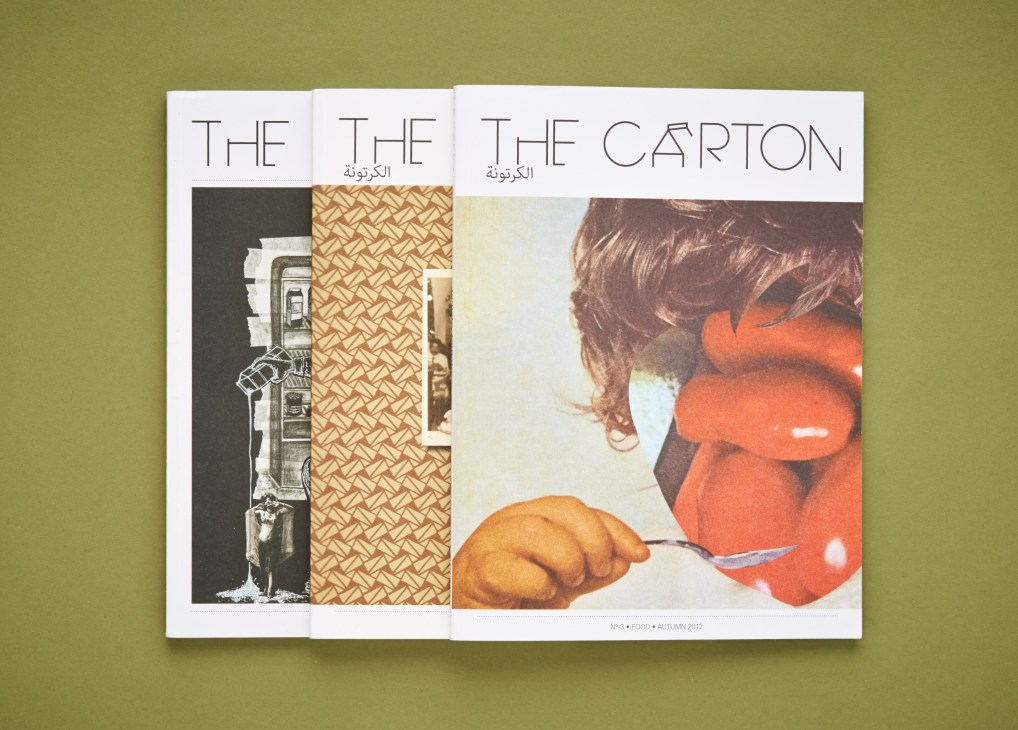 Three issues of The Carton magazine displayed against a sage green background, showing minimalist covers with typography and food imagery.