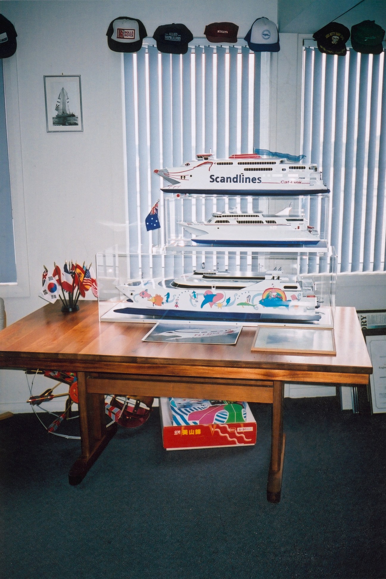 Robert Clifford's office displaying model ships and ferries on a wooden desk with maritime memorabilia.