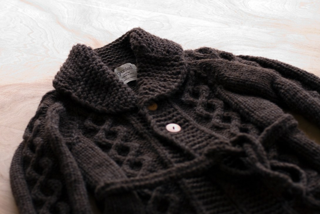 Granted cable sweater in charcoal grey showing the brand label and knit detail