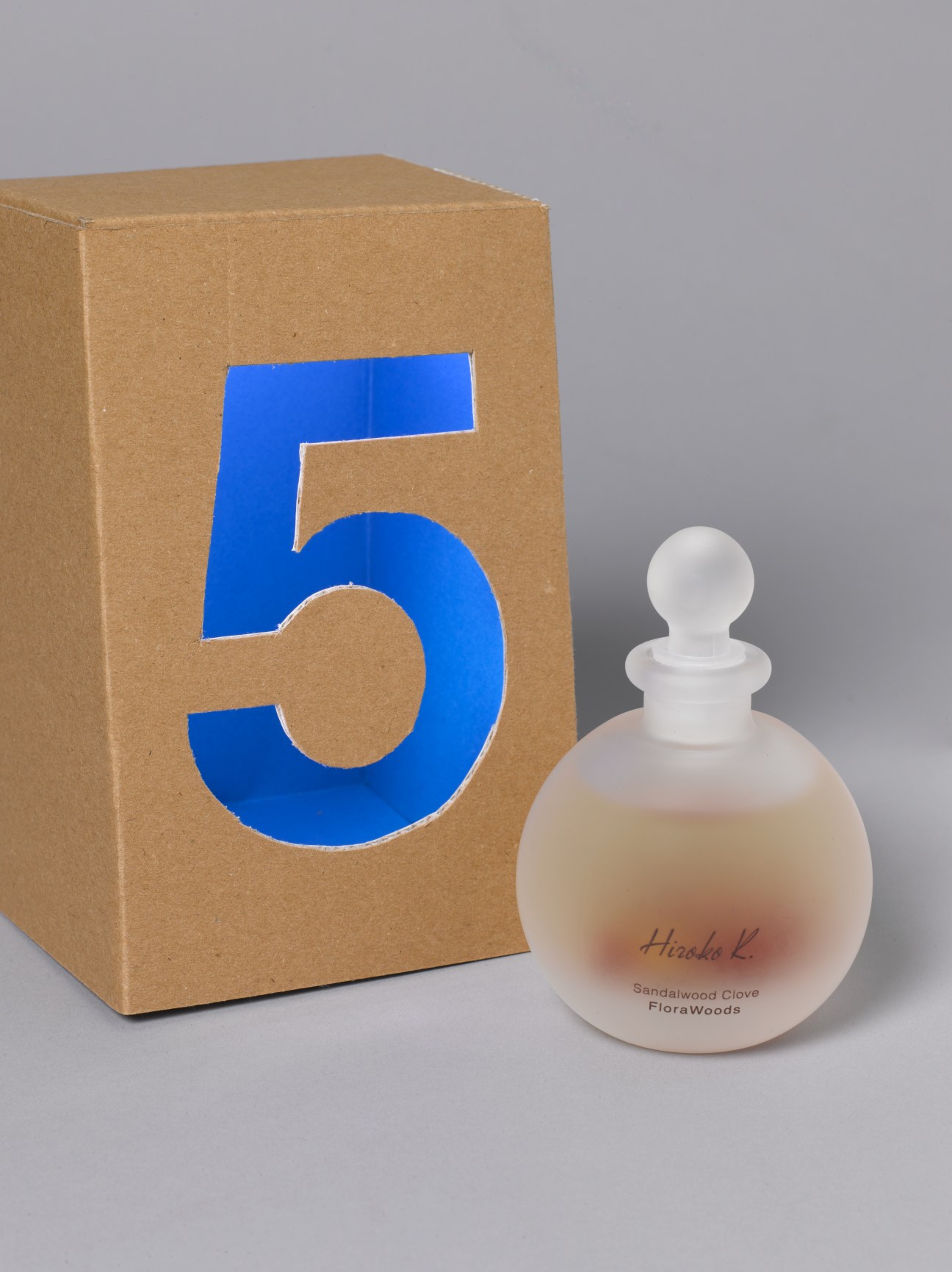 Hiroko K Sandalwood Clove fragrance bottle next to numbered cardboard box