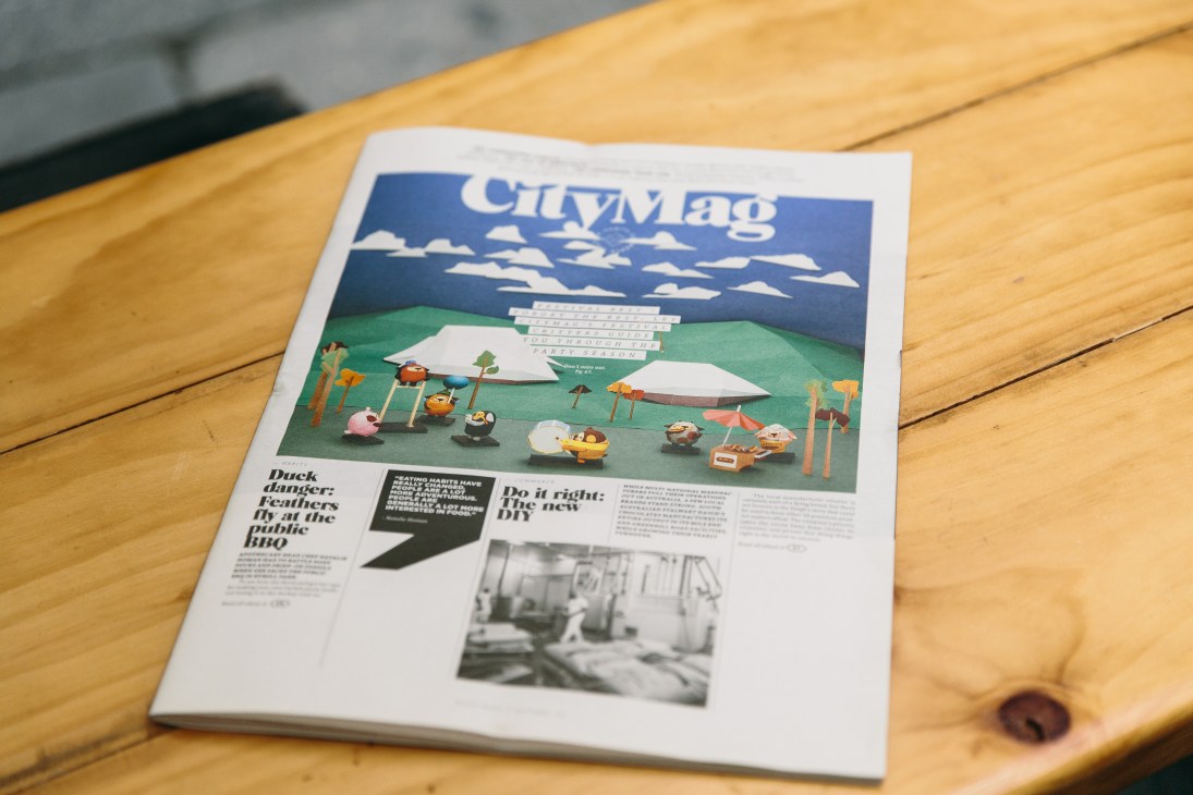 CityMag issue four lying on a wooden table, featuring an illustrated cover with a landscape scene and the magazine's logo.