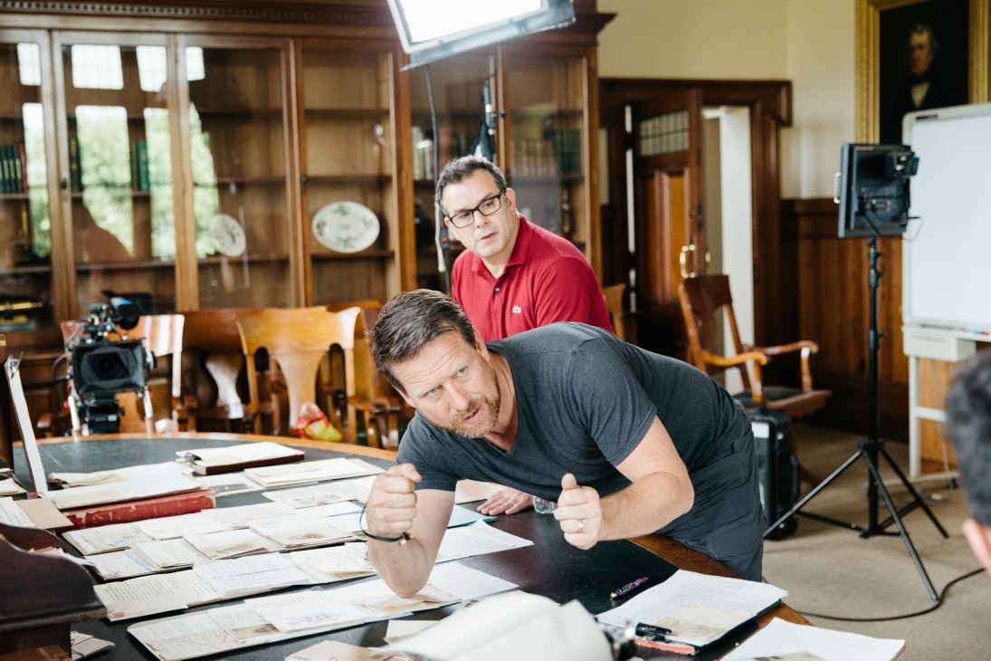 Director giving instructions on the set of History Channel's 'Changed Forever' in a historic interior.