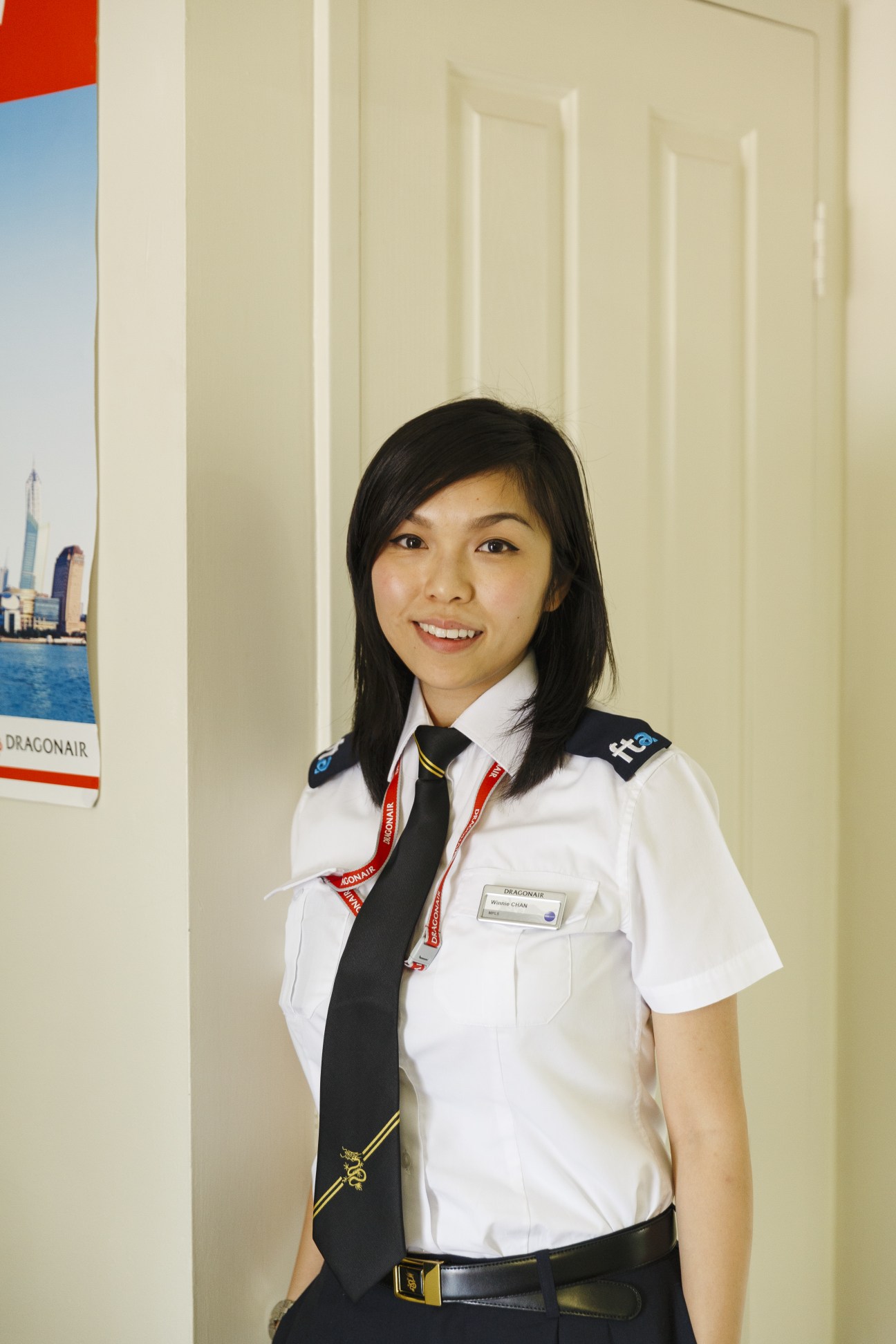Winnie Chan, a Dragonair cadet, smiles in her uniform with black tie and name badge.