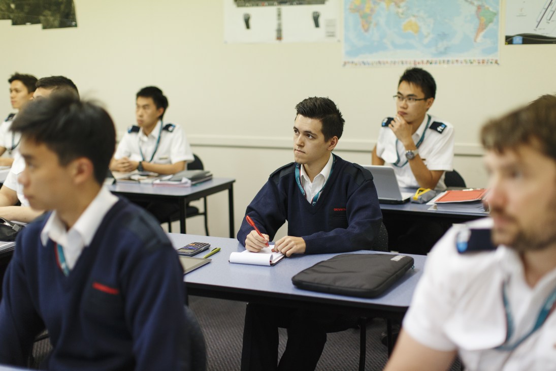 Pilot cadets in uniform sitting at desks during a ground school classroom lesson at Flight Training Adelaide.
