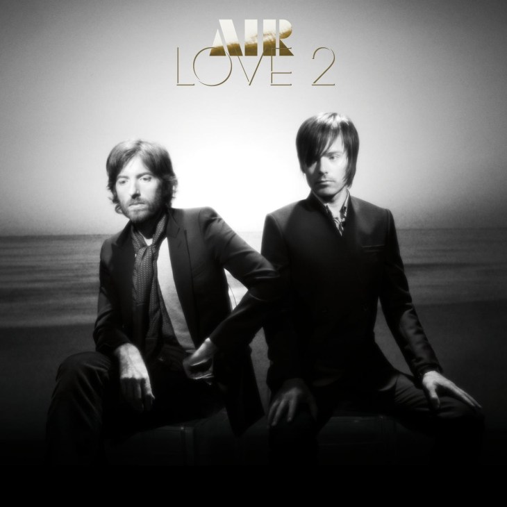 Black and white album cover for Air's Love 2 featuring two men in suits against a seascape background.