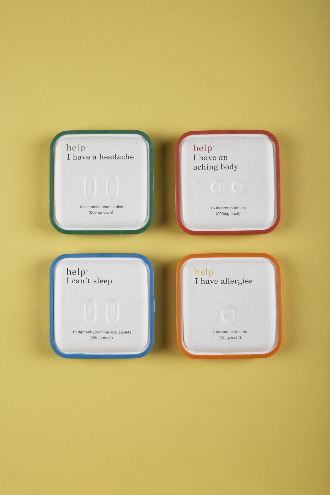 Four colorful Help Remedies medicine boxes on a yellow background, each labeled for different ailments: headache, aching body, insomnia, and allergies.