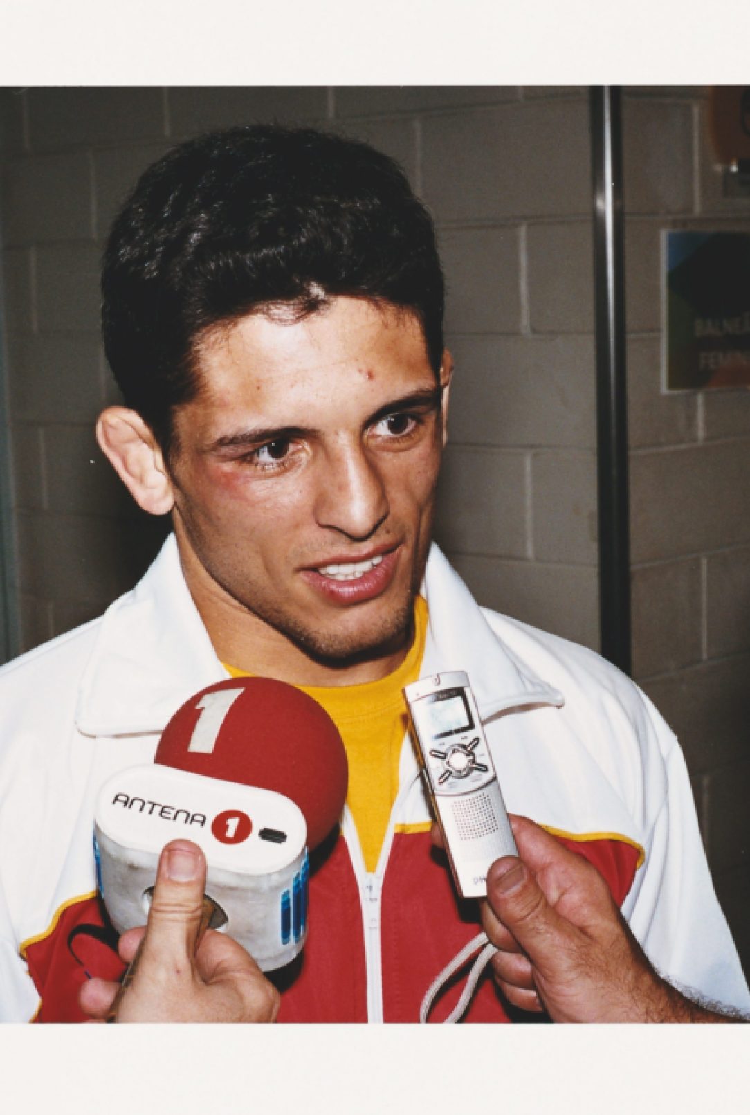 A member of the Portuguese judo team receives instruction during competition.