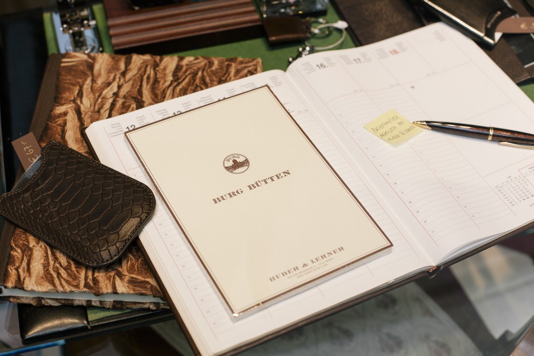 Huber & Lerner stationery displayed on an open planner with leather accessories and writing instruments.