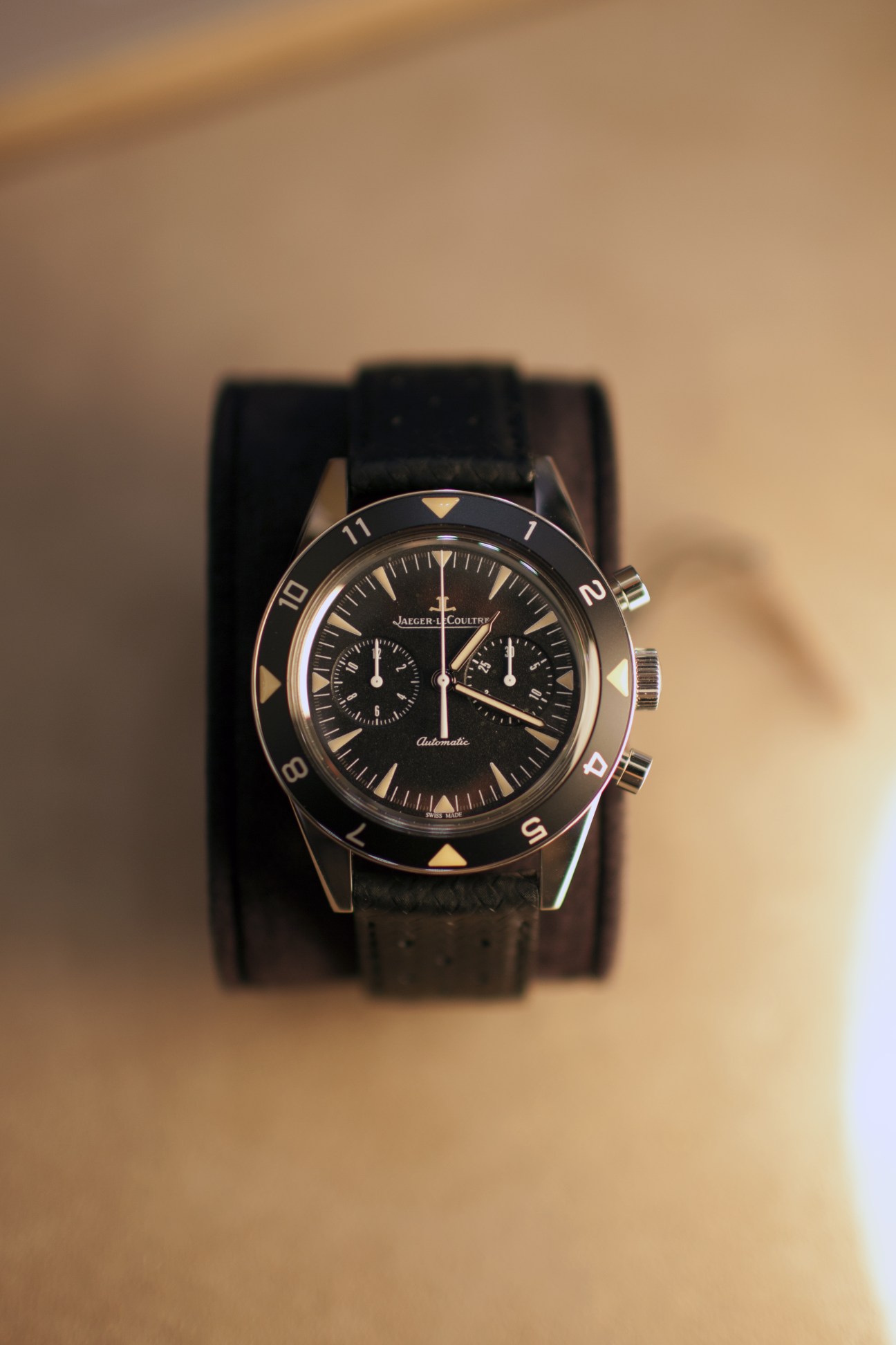 Jaeger-LeCoultre Deep Sea Vintage Chronograph watch with black dial and leather strap on neutral background.