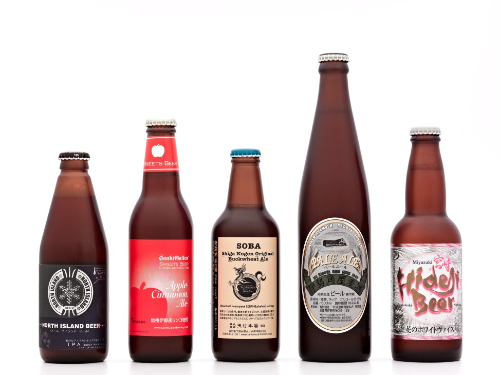 Five Japanese craft beer bottles arranged in a row against a white background.