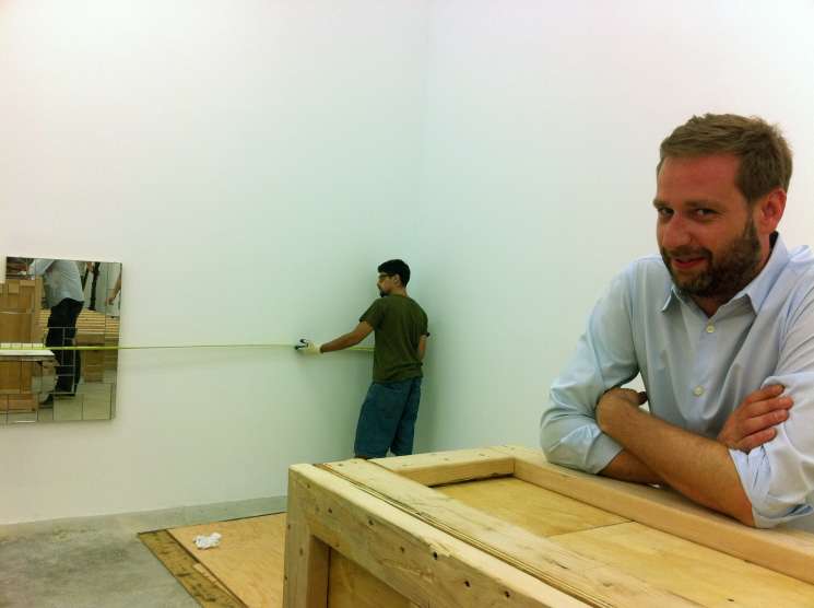 Joel Mesler, founder of Untitled gallery, in his New York Lower East Side gallery space with artwork being installed.
