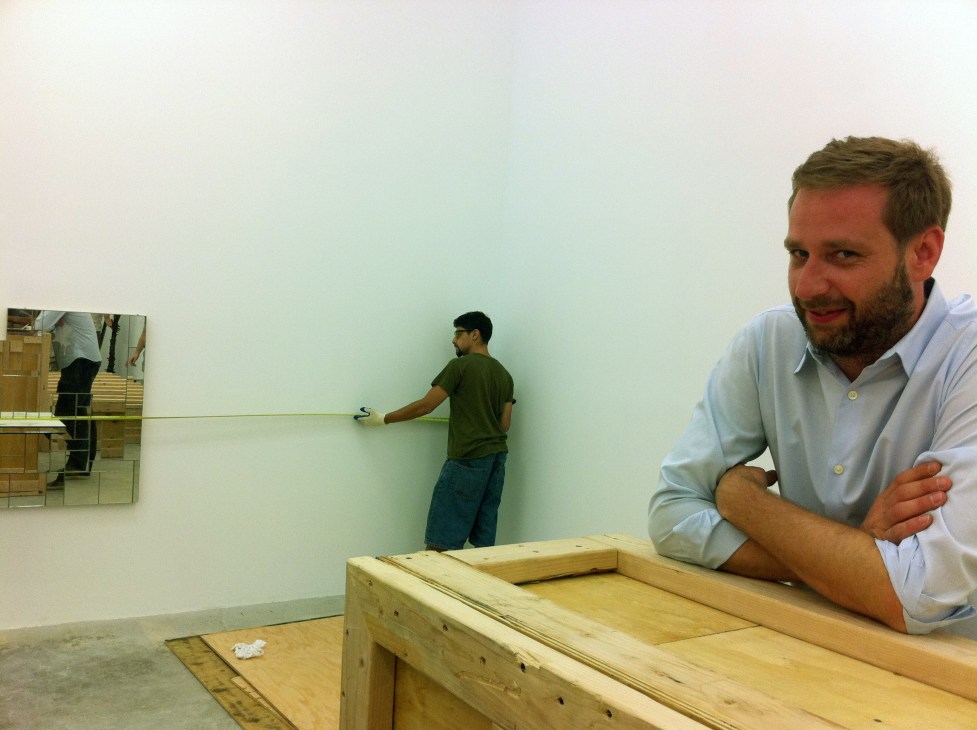 Joel Mesler, founder of Untitled gallery, in his New York Lower East Side gallery space with artwork being installed.