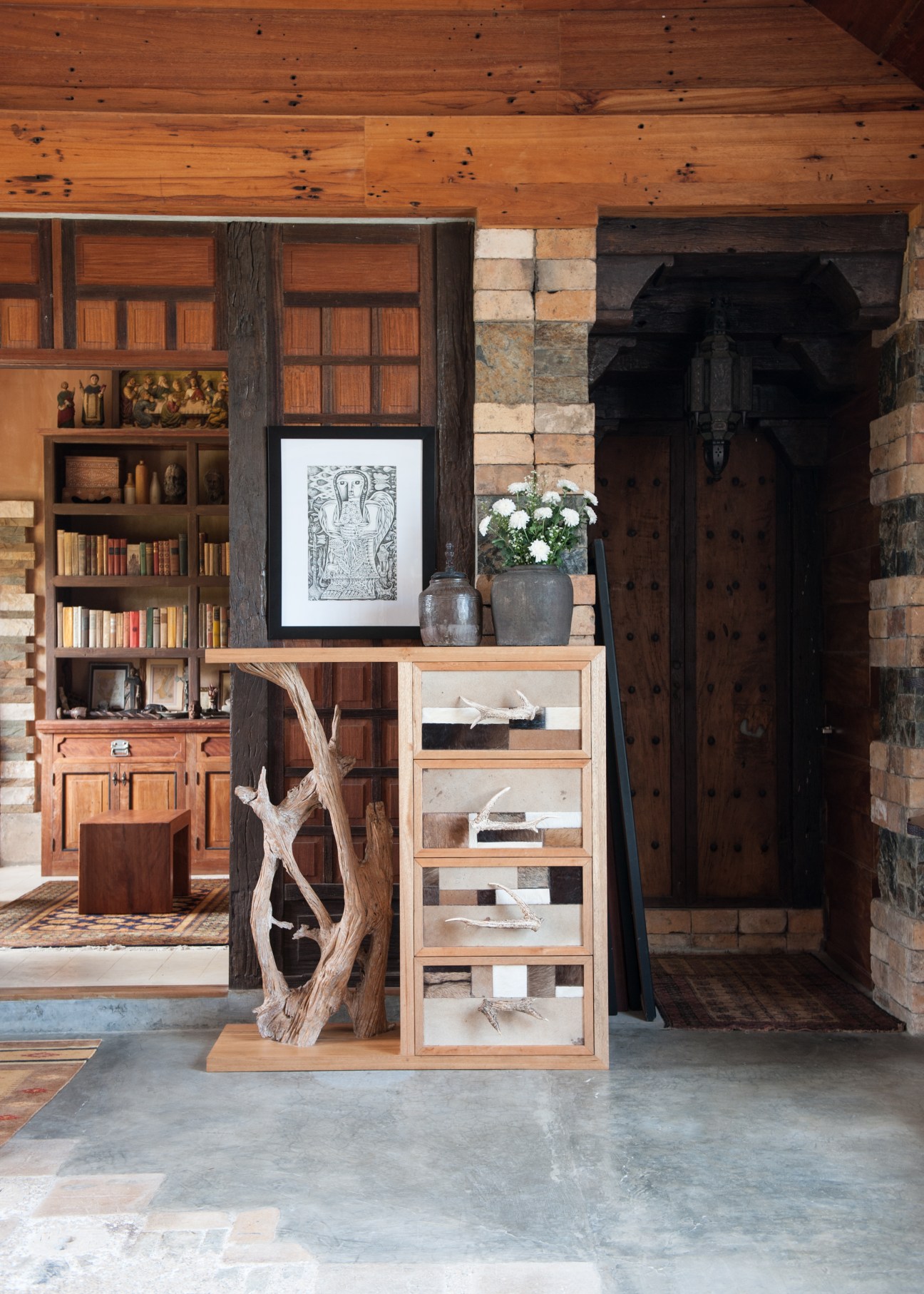 Interior of Karl Aguila's home-museum displaying handcrafted wooden furniture and salvaged materials.
